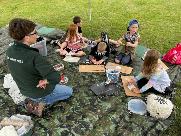 Country Parks Ranger and children enjoy a craft session