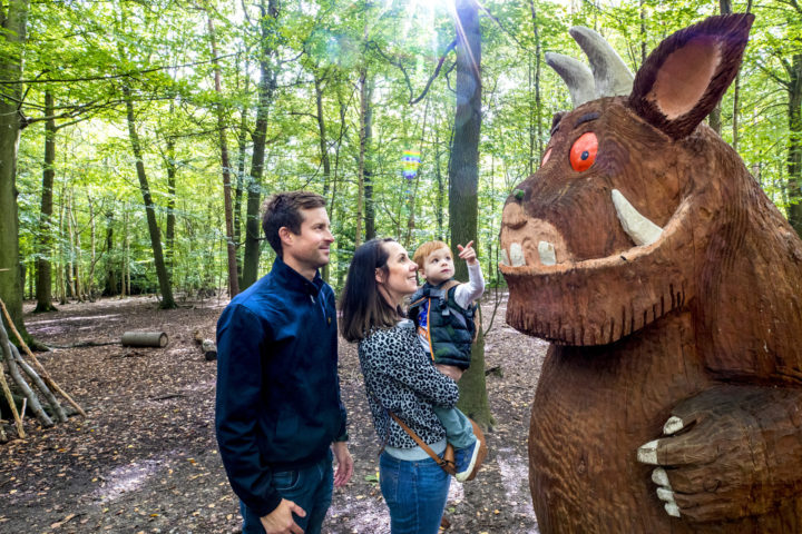 Family looking at The Gruffalo wooden sculpture