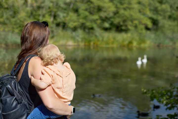 Mum and little one relax at the lake at Great Notley