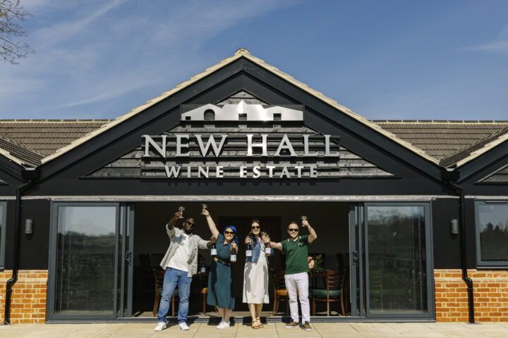 People standing in the entrance to New Hall Wine Estate building