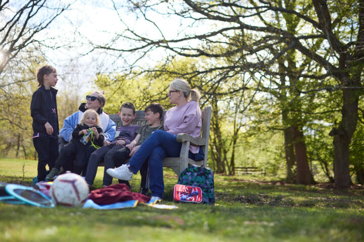 Family and friends on a picnic bench