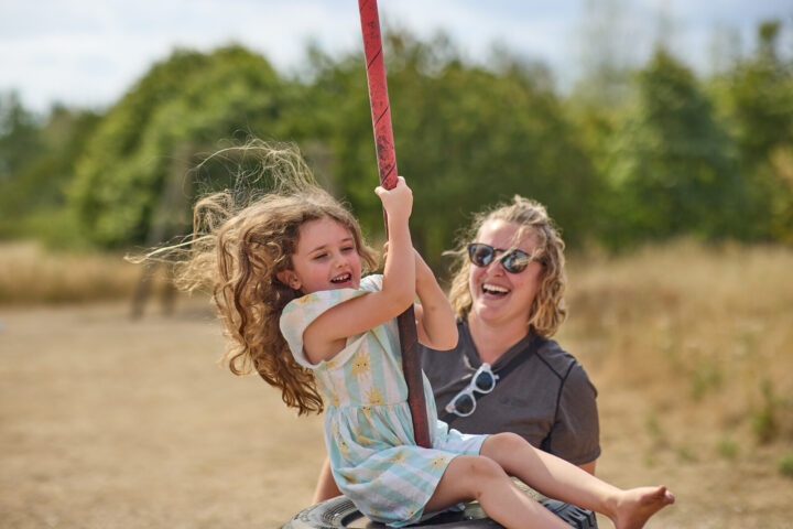 Mum and daughter at Great Notley on the swings