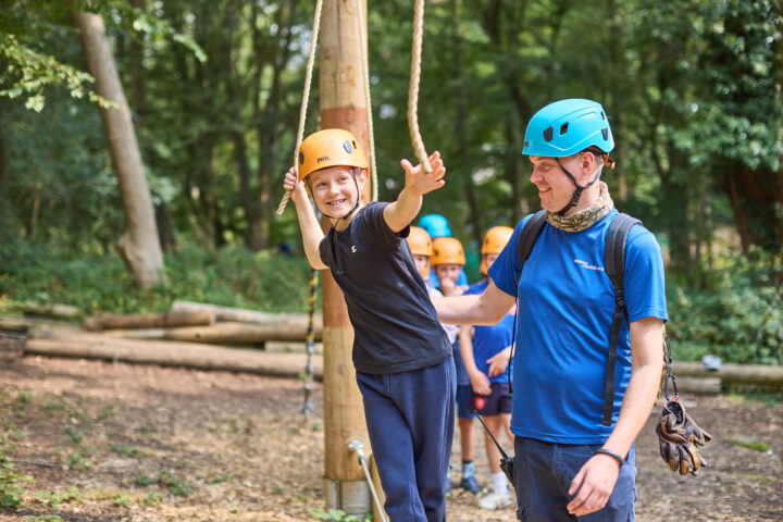 Boy taking part in outdoor activity with instructor