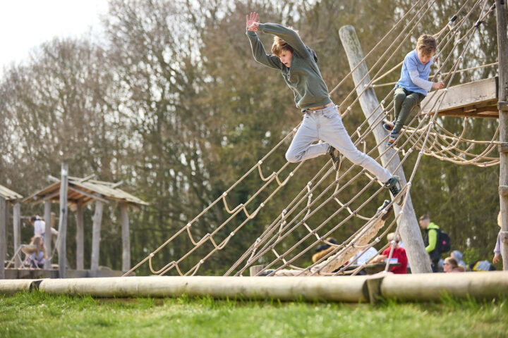 Boy jumping off play equipment