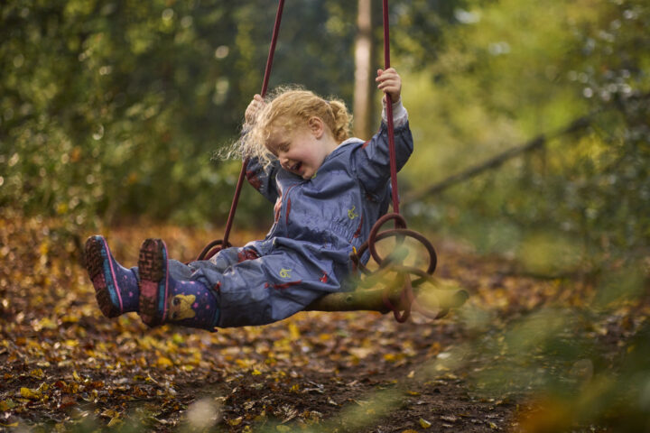 child on rope swing