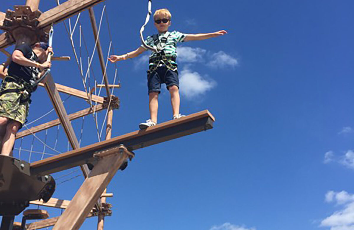 A child balancing at Sky Ropes