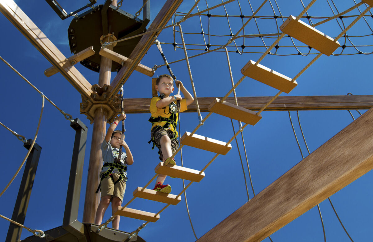 Two boys balancing n the Sky Ropes equipment