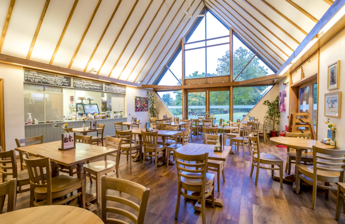 A beamed cafe with tables and seating