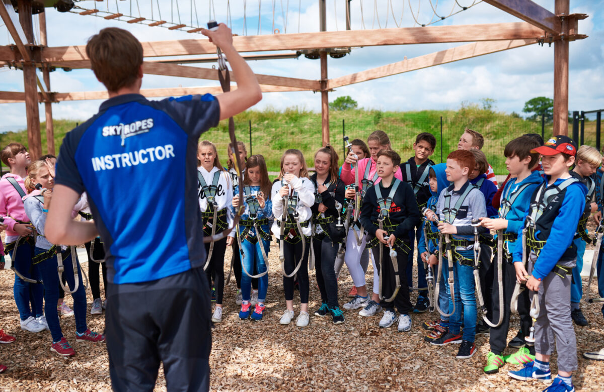 An instructor briefing children at Sky Ropes