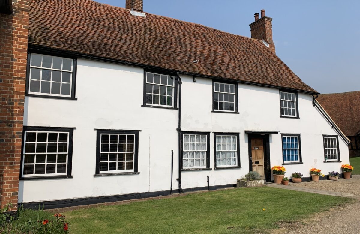 An old brick house painted white