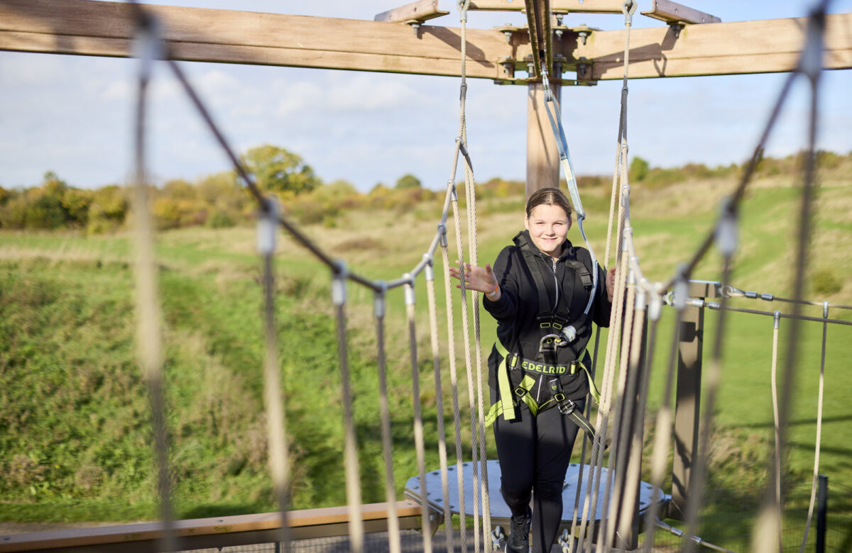 Girl walking across bridge