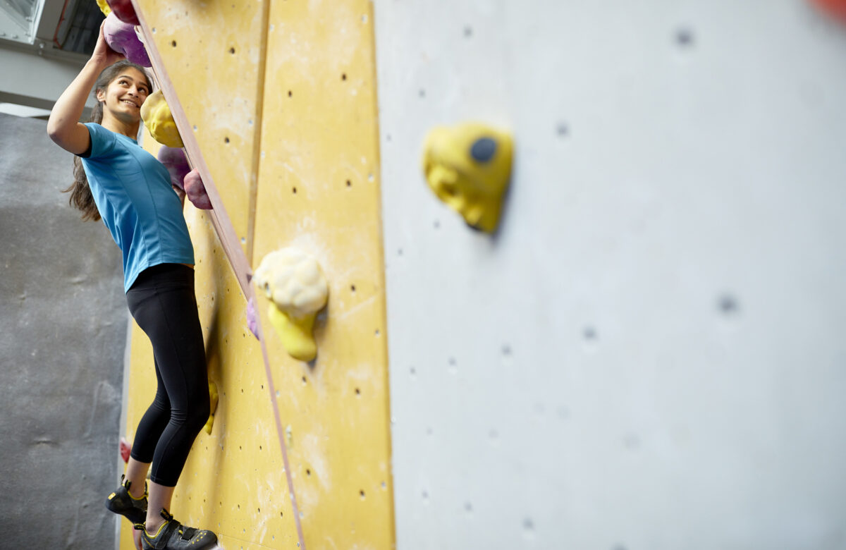 A lady on a climbing wall