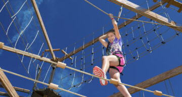 A child climbing at Sky Ropes