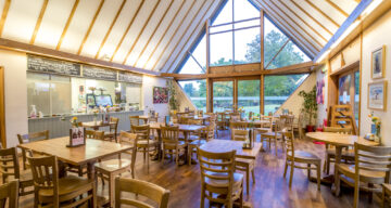 A beamed cafe with tables and seating