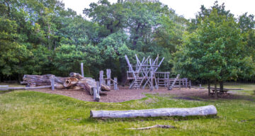 Apparatus at an outdoor adventure playground near a forest