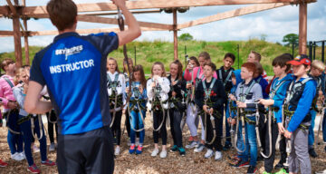 An instructor briefing children at Sky Ropes