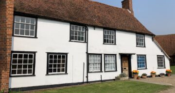 An old brick house painted white
