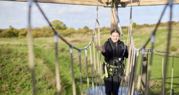 Girl walking across bridge