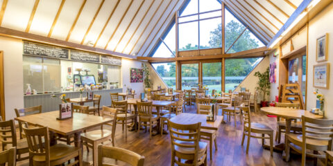 A beamed cafe with tables and seating