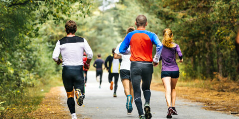 Adult men and women running