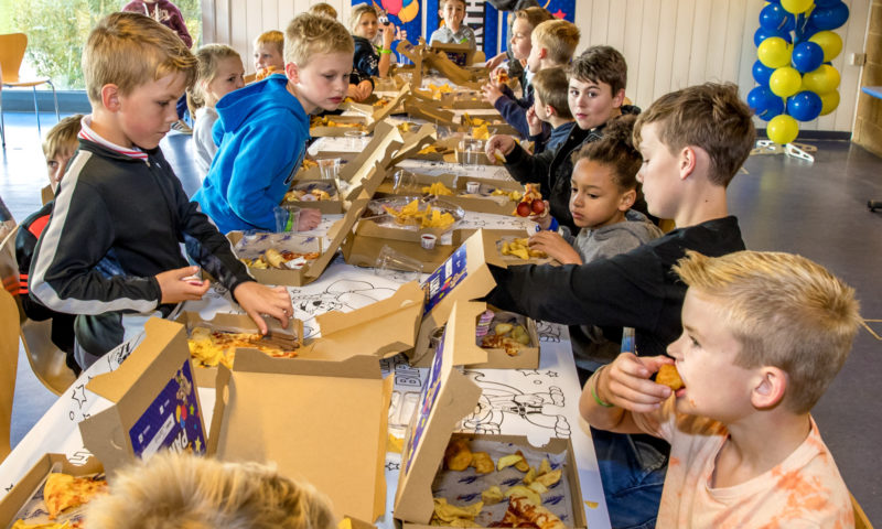 A children's birthday party enjoying the birthday tea and cake